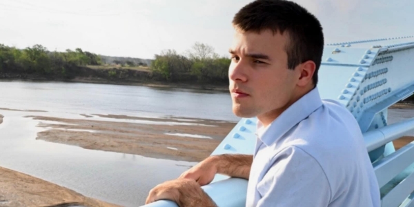 Participant representing Mosaic Community in Claremore, OK standing on a bridge